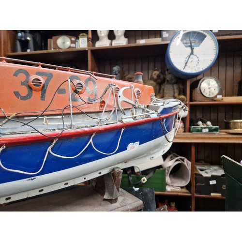 72 - A model lifeboat on stand, approx. 95cm long