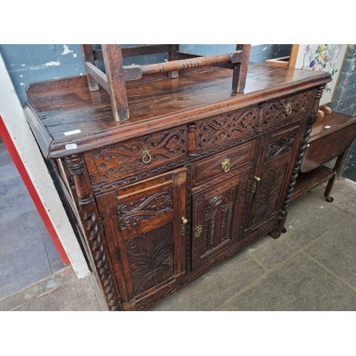 1029 - An 18th century carved oak cabinet/sideboard.