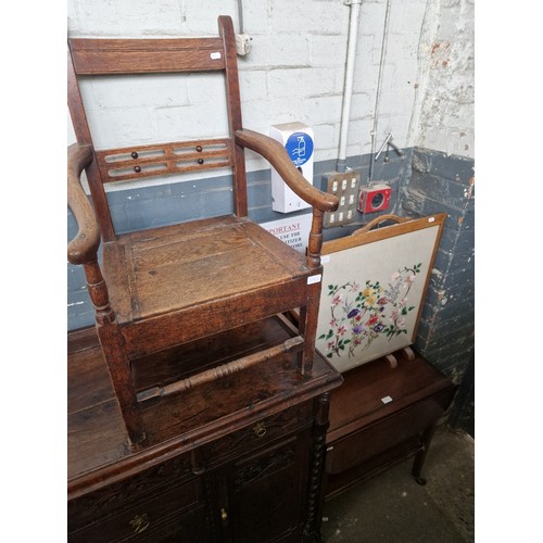 1030 - An oak commode chair together with a tapestry firescreen and and a mahogany trolley.