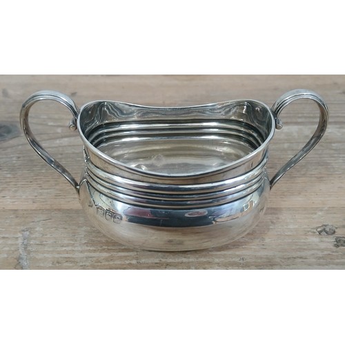 505 - A hallmarked silver twin handled sugar bowl, length 14m, weight 137.7g.