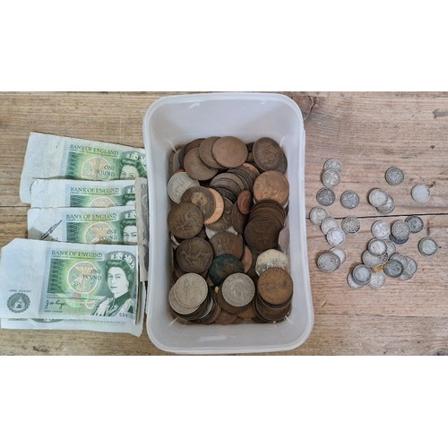 566 - A tub of assorted GB coins & banknotes to include some silver threepences etc.