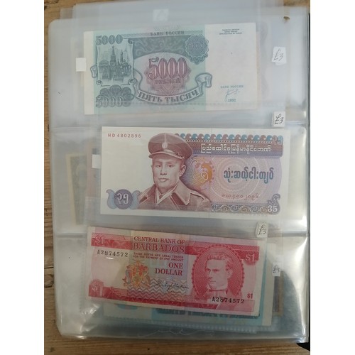 563 - A file of assorted world banknotes.