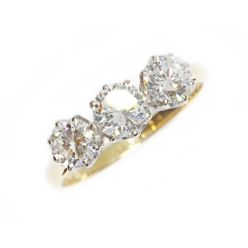 591 - A three stone diamond trilogy ring, the round brilliant cut stones weighing approximately 0.37, 0.48... 