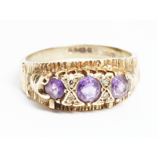 601 - A hallmarked 9ct gold three stone amethyst ring, gross weight 4.1g, size R.