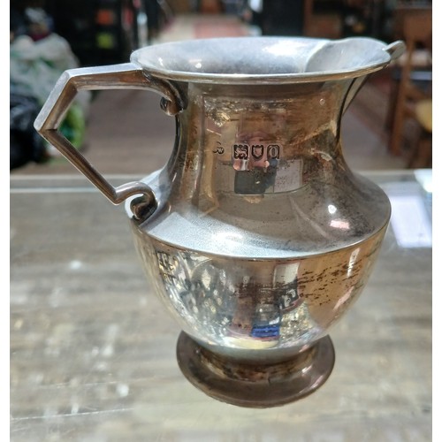 582 - A hallmarked silver cream jug, height 10cm, weight 5.6ozt.