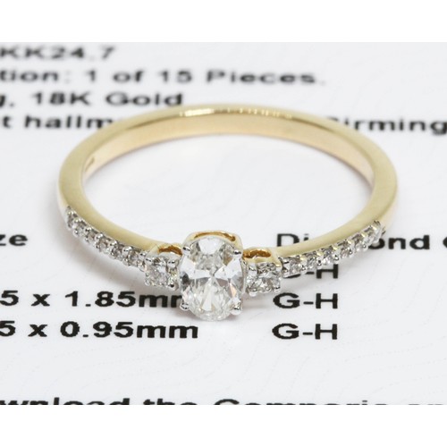 636 - An 18ct gold diamond ring, the principal oval cut diamond weighing approximately 0.35cts, set betwee... 