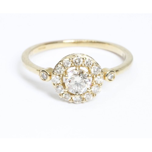 651 - A 9ct gold tinted diamond cluster ring, the principal round brilliant cut stone weighing approximate... 