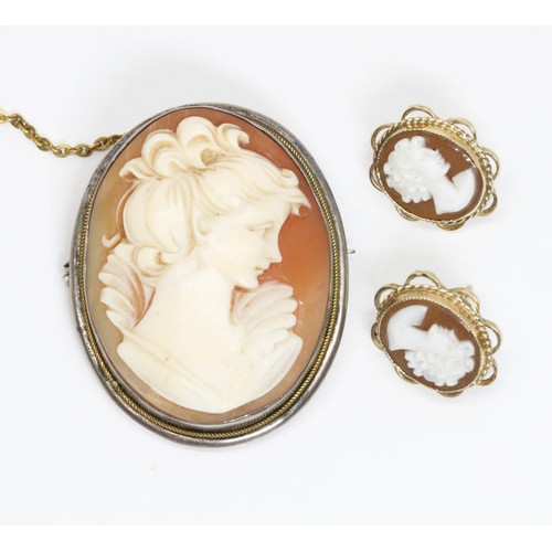 666 - A pair of 9ct gold shell cameo earrings and white metal mounted shell cameo brooch.