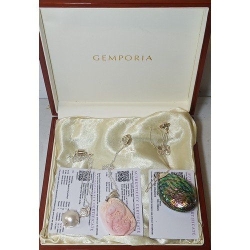 658 - A Gemporia jewellery box and contents comprising a pink conch cameo pendant depicting  a koi carp an... 