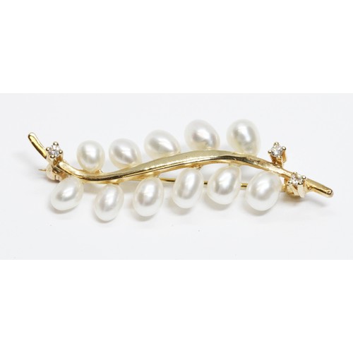 670 - A cultured pearl and diamond brooch, marked '585', length 45mm, gross weight 3.9g.