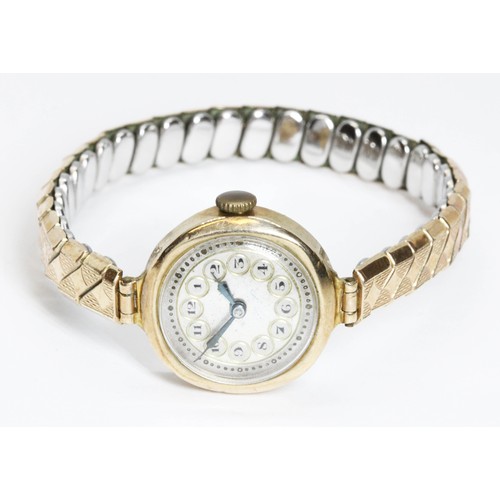 674 - A ladies 9ct gold wristwatch with gold plated strap.