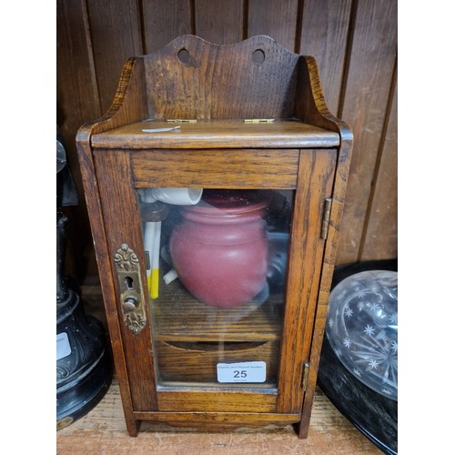 25 - A small oak smokers cabinet with jar and assorted pipes etc.