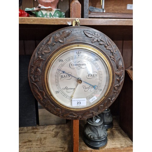 23 - A carved oak barometer