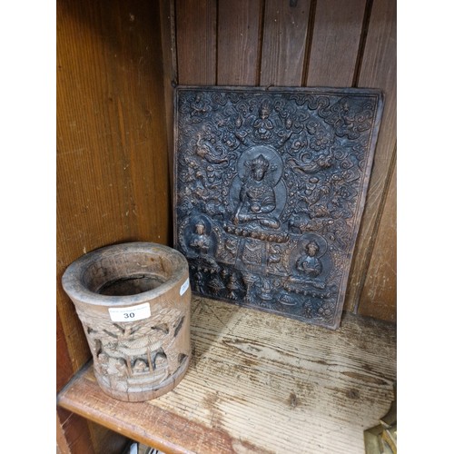 30 - An eastern embossed brass plaque and a carved bamboo brush pot.