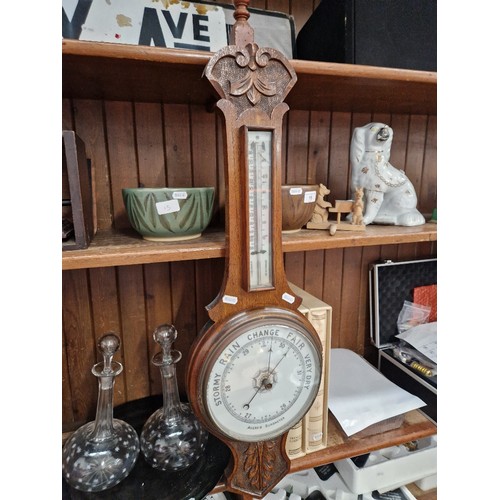 16 - An early 20th century carved oak aneroid barometer.