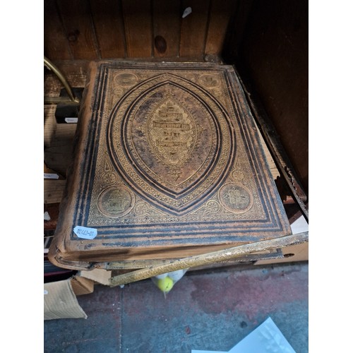 59 - A leather and metal bound Bible with coloured plates.