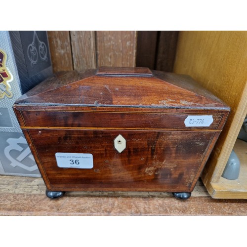 36 - A George III inlaid mahogany tea caddy.