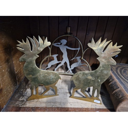 58 - A brass candle holder and two brass deer plagues.