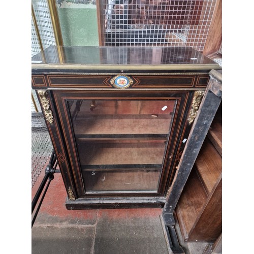 847 - A Victorian gilt metal mounted ebonised dwarf bookcase with sevres type porcelain panel, height 109c... 