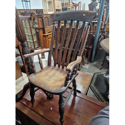 863 - A stained beech country armchair.