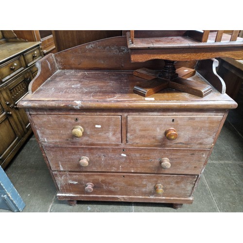 877 - A Victorian stained pine chest of drawers with rail back, width 90cm, depth 45cm & height 107cm.