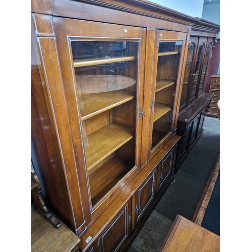 884 - A French reproduction cherry wood cabinet bookcase, width 176cm, depth 47cm & height 210cm.