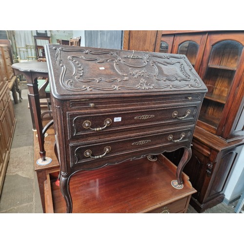 894 - A continental carved oak bureau, width 90cm, depth 42cm & height 96cm.