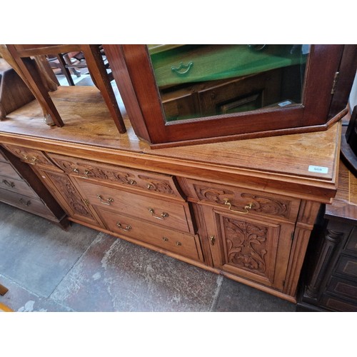 908 - An Edwardian carved satin walnut sideboard.