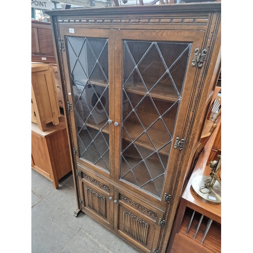 917 - A Priory style leaded glass bookcase.