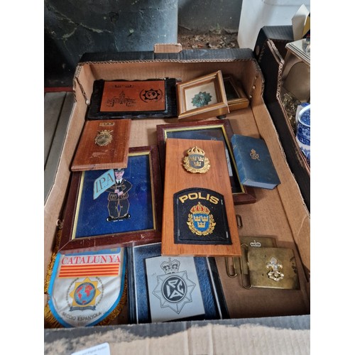 129 - A box of assorted plagues and military buckles.