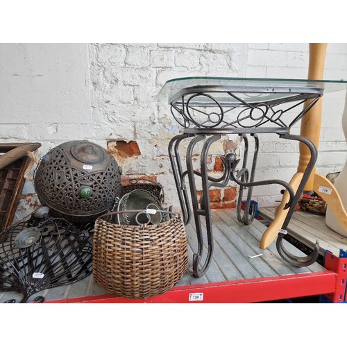 120 - A mixed lot comprising wrought metal and glass top table, decorative hanging and wall mounting metal... 