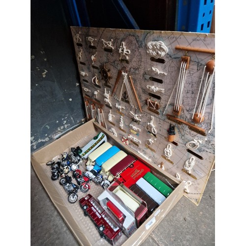 108 - A box of assorted model vehicles and a knot display.