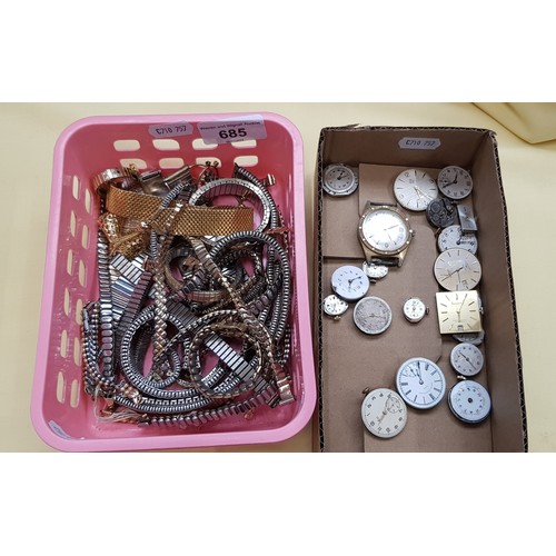 685 - A box of wrist watch movements and a box of watch straps.