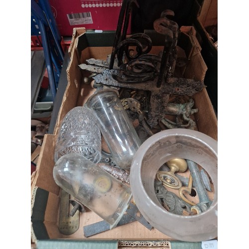 200 - A mixed lot of metalware and glass including horse brasses, glass domes, wrought metal hanging baske... 