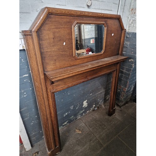 938 - A 1920s/1930s Art Deco oak fire surround with mirror.