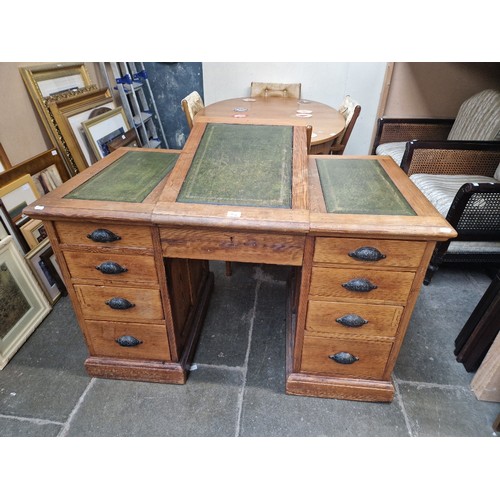 933 - A pitch pine twin pedestal desk, with hinged central writing surface, circa 1900.