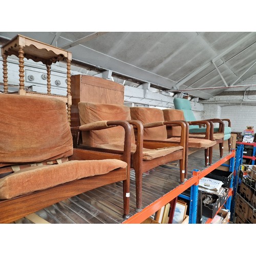 978 - A set of four mid 20th century teak lounge armchairs.