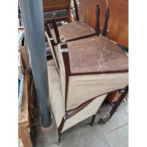 982 - An Edwardian inlaid mahogany framed settee and two matching tub chairs.