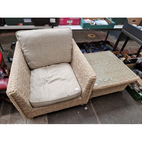 990 - A conservatory armchair and matching glass top table.