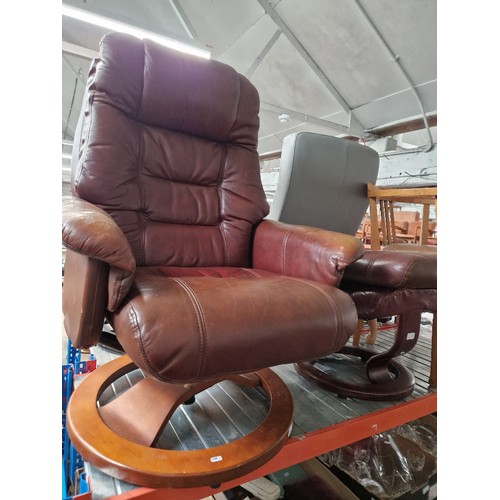 987 - A Stressless style recliner armchair together with an Ekornes brown leather stool.