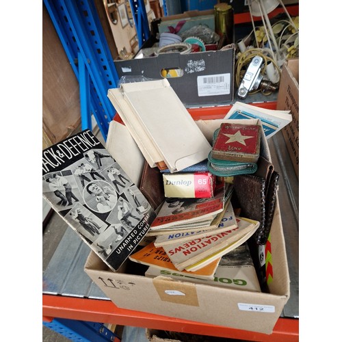 412 - A box of mixed items to include wartime booklets, Ian Allen spotting books, small cigarette tin from... 