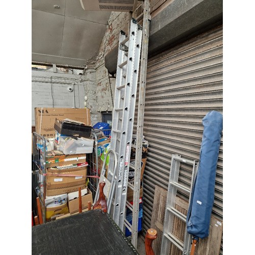 418 - 2 sets of aluminium extension ladders and a small set of aluminium ladders