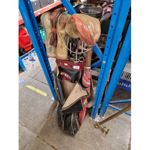 422 - A vintage golf bag with divider tubes and a set of Spalding Top Flite Synchro-Dined clobs