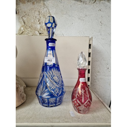 462 - A Bohemian blue flash cut glass decanter together with a smaller red bohemian cut glass decanter.