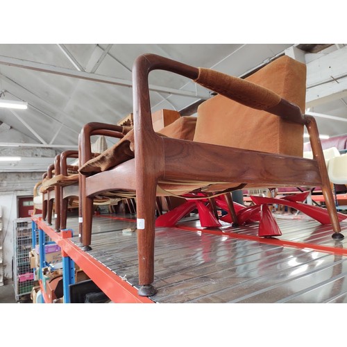 978 - A set of four mid 20th century teak lounge armchairs.