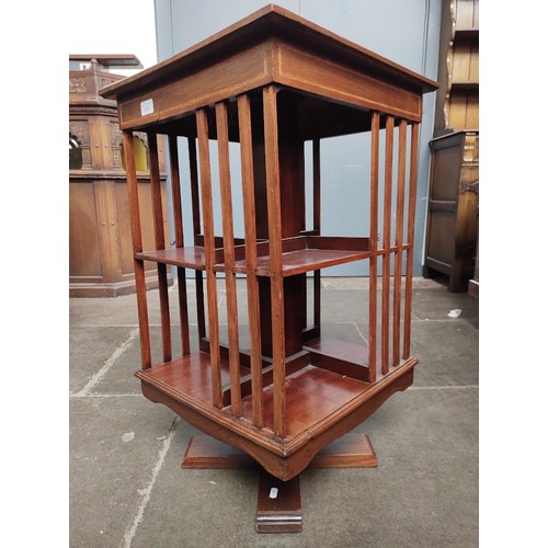 876 - An early 20th century revolving bookcase, height 76cm.