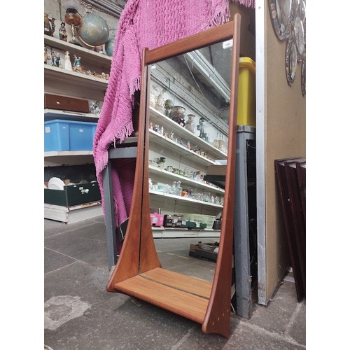 1000 - A mid 20th century Danish wall mirror with shelf.