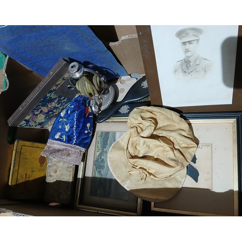 129 - A box of assorted collectables including caps, brass frame with military portrait and Wiltshire Regi... 