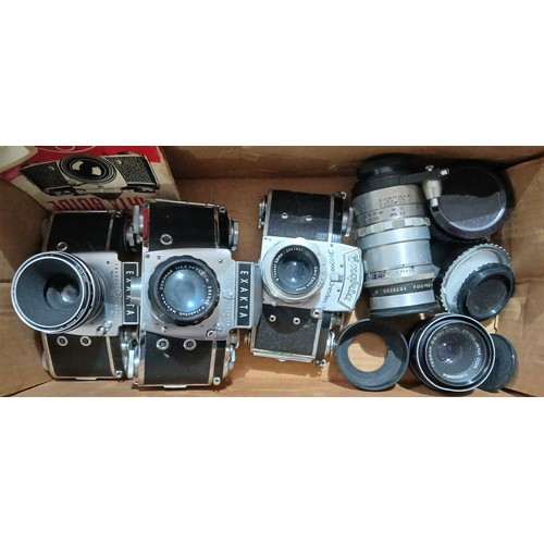 177 - Three Exakta cameras with spare lenses and filters.