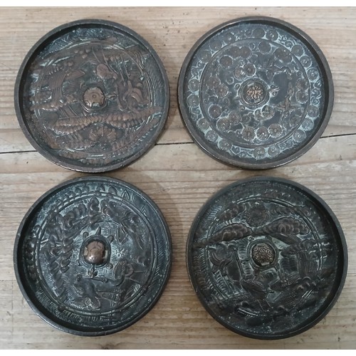 246 - A group of four Japanese bronze Kagami mirrors, diameter er10.5cm each.